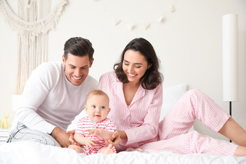 Fototapeta na wymiar Cute baby with parents in bedroom