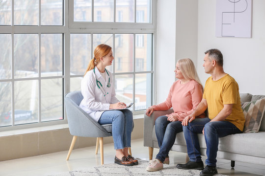 Mature Couple Visiting Doctor In Clinic