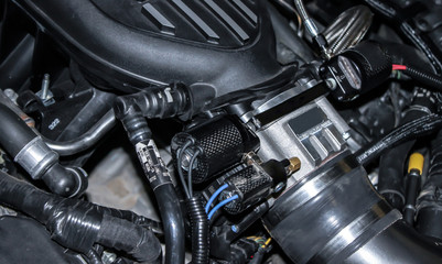 A side view of a custom engine black and chrome setup from a truck close up.