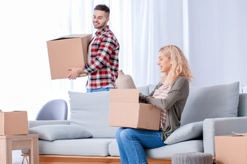 Couple with moving boxes in their new home