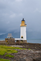 Tobermory Lighthouse - white tower at north side of the island. Popular trekking route at Island of Mull, Scotland.