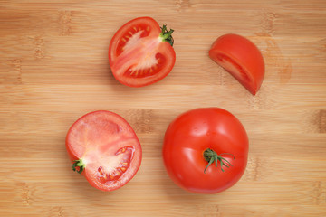 sliced fresh tomatoes on wooden background
