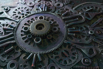 Machine gear, metal cogwheels, nuts and bolts and keys.Selective focus.