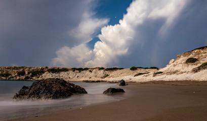 Sandy and pebble beach of the Mediterranean Sea, shot in calm weather at night with a long exposure.