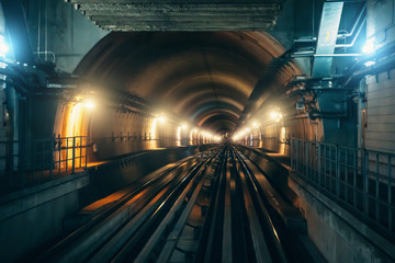 Underground metro tunnel with subway railroad and illumination in dubai, UAE.