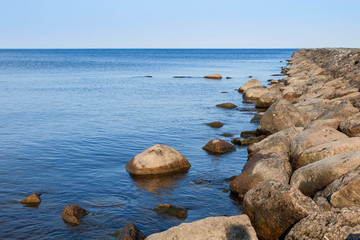 Lake Ladoga stones on the coast , Sunny day, skyline and blue sky and water