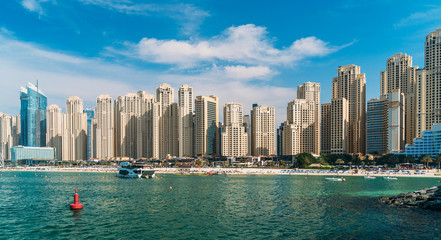 Fototapeta na wymiar Panorama of skyscrapers on coast of Dubai Marina, view from water, UAE.