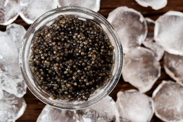 Top view of black surgeon or beluga caviar on wooden table