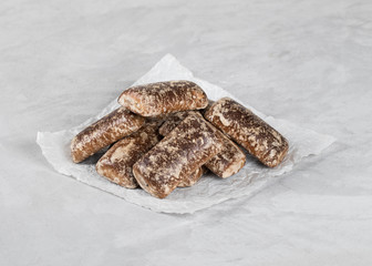 Gingerbread cookies chocolate with icing sugar on a light background