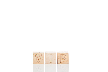 Wooden cubes with letters vip on a white background