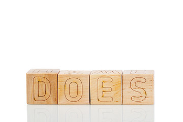 Wooden cubes with letters does on a white background