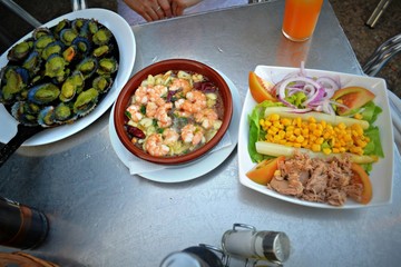 seafood shrimps with salad and vegetables on the table