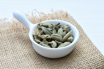 Dry cardamom seed (Elettaria cardamomum) displayed in containers