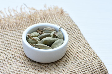 Dry cardamom seed (Elettaria cardamomum) displayed in containers