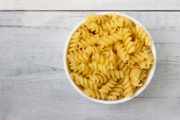 Fusilli Pasta   isolated on a wooden background.