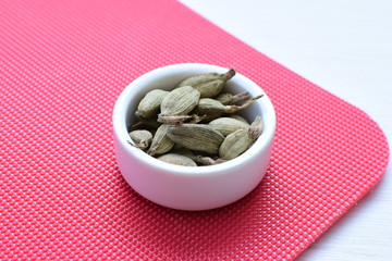 Dry cardamom seed (Elettaria cardamomum) displayed in containers