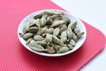 Dry cardamom seed (Elettaria cardamomum) displayed in containers