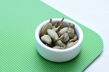 Dry cardamom seed (Elettaria cardamomum) displayed in containers