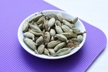Dry cardamom seed (Elettaria cardamomum) displayed in containers
