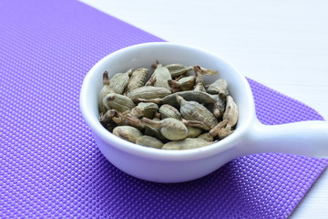 Dry cardamom seed (Elettaria cardamomum) displayed in containers
