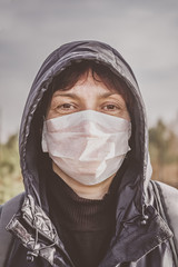 Portrait of a woman in a disposable medical mask. Coronavirus epidemic. Flu. Coronavirus epidemic. Wuhan symptoms of coronavirus and epidemic virus. Chinese woman in a mask.