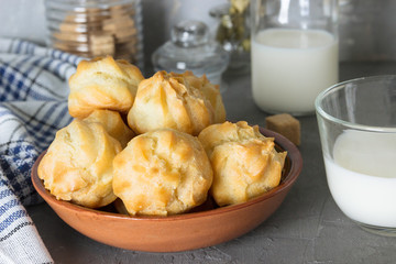 Homemade pastries: profiteroles with butter cream and milk.