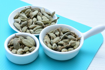 Dry cardamom seed (Elettaria cardamomum) displayed in containers