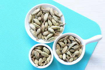 Dry cardamom seed (Elettaria cardamomum) displayed in containers