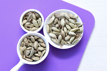 Dry cardamom seed (Elettaria cardamomum) displayed in containers