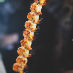 Vibrant picture of delicious grilled shrimp prawn spit on grill with flames in background, Grilled shrimps on the flaming grill on a banquet event, catering table
