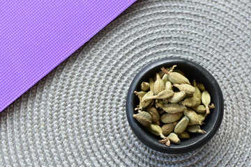 Dry cardamom seed (Elettaria cardamomum) displayed in containers