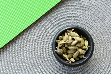Dry cardamom seed (Elettaria cardamomum) displayed in containers