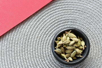 Dry cardamom seed (Elettaria cardamomum) displayed in containers