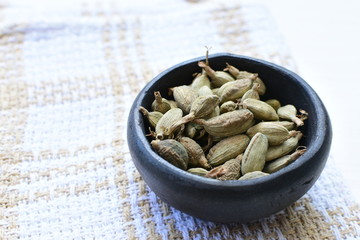 Dry cardamom seed (Elettaria cardamomum) displayed in containers
