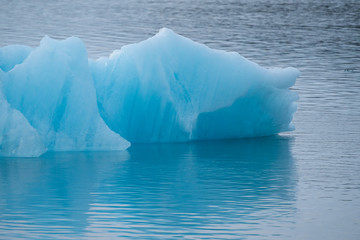 Fototapeta na wymiar Melting blue ice in cold water