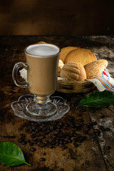 cup of coffee and cookies on wooden table