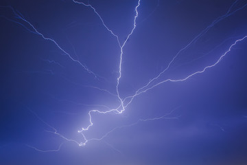 Lightning strikes in the city seen through the window, thunder in the night, massive lightning on...