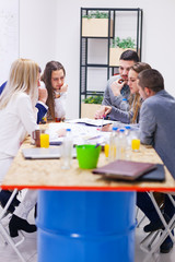 group of successful young architects in modern workplace, having a creative meeting.