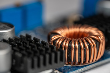 Electronics background photo of an inductor with detailed copper wire winding. Electronic...