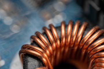 Electronics background photo of an inductor with detailed copper wire winding. Electronic...