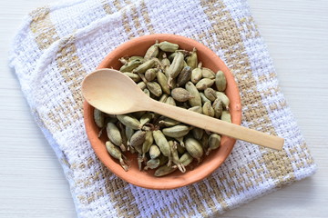 Dry cardamom seed (Elettaria cardamomum) displayed in containers
