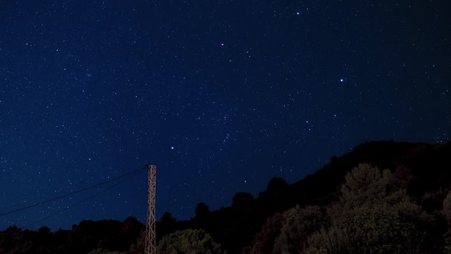 Timelapse of stars with mountain and electric pole, shooting star 4k