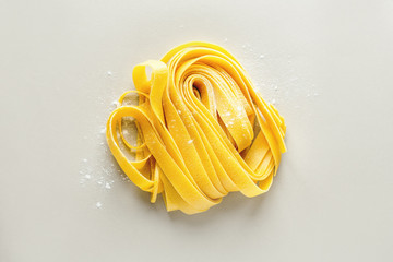 Dry tagliattele on table with flour