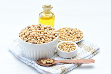 Raw soybeans (Glycine max) displayed in containers and accompanied by oil