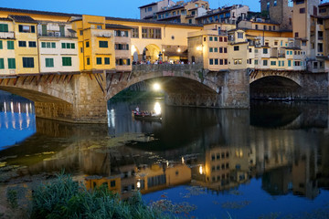 Fototapeta na wymiar The medieval stone arch bridge Ponte Vecchio over the Arno River in Florence, Italy.