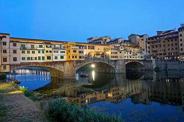 Naklejka premium The medieval stone arch bridge Ponte Vecchio over the Arno River in Florence, Italy.