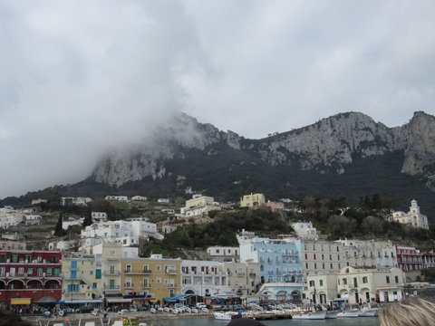 View of the coast and port of Capri, Italy on a sunny but cloudy day 