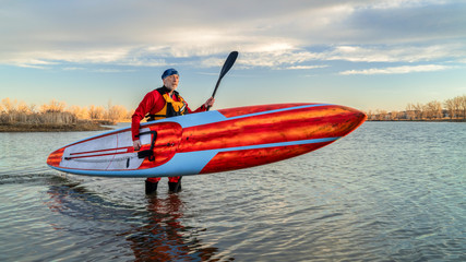 paddling stand up paddleboard in winter