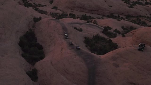 Aerial Drone Four Wheelers Offroading 4x4 Jeepers Wheeling & Driving on Hell's Revenge Trail at Sand Flats Recreation Area Near Moab, Utah U.S.A.