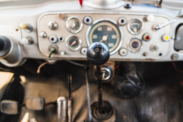 Dashboard and gear lever of an old industrial vehicle in disuse.